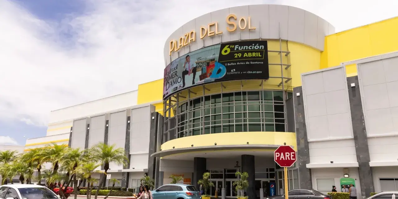 A yellow building with a sign on it.