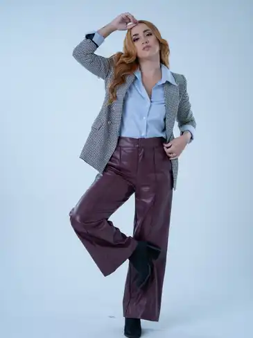 Burgundy leather pants posing on a white background.