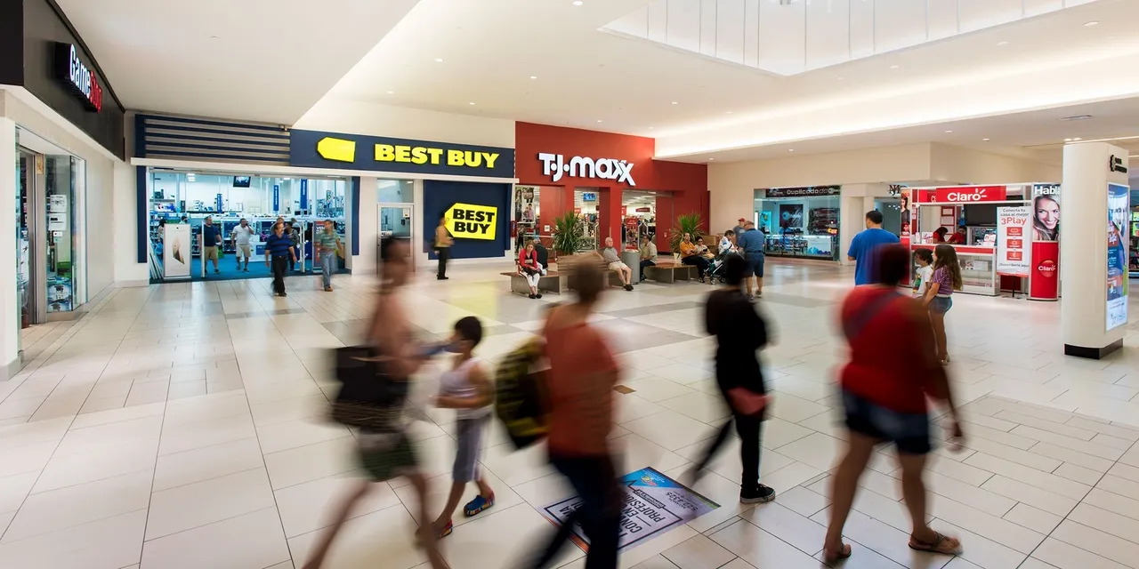 People walking through a shopping mall.