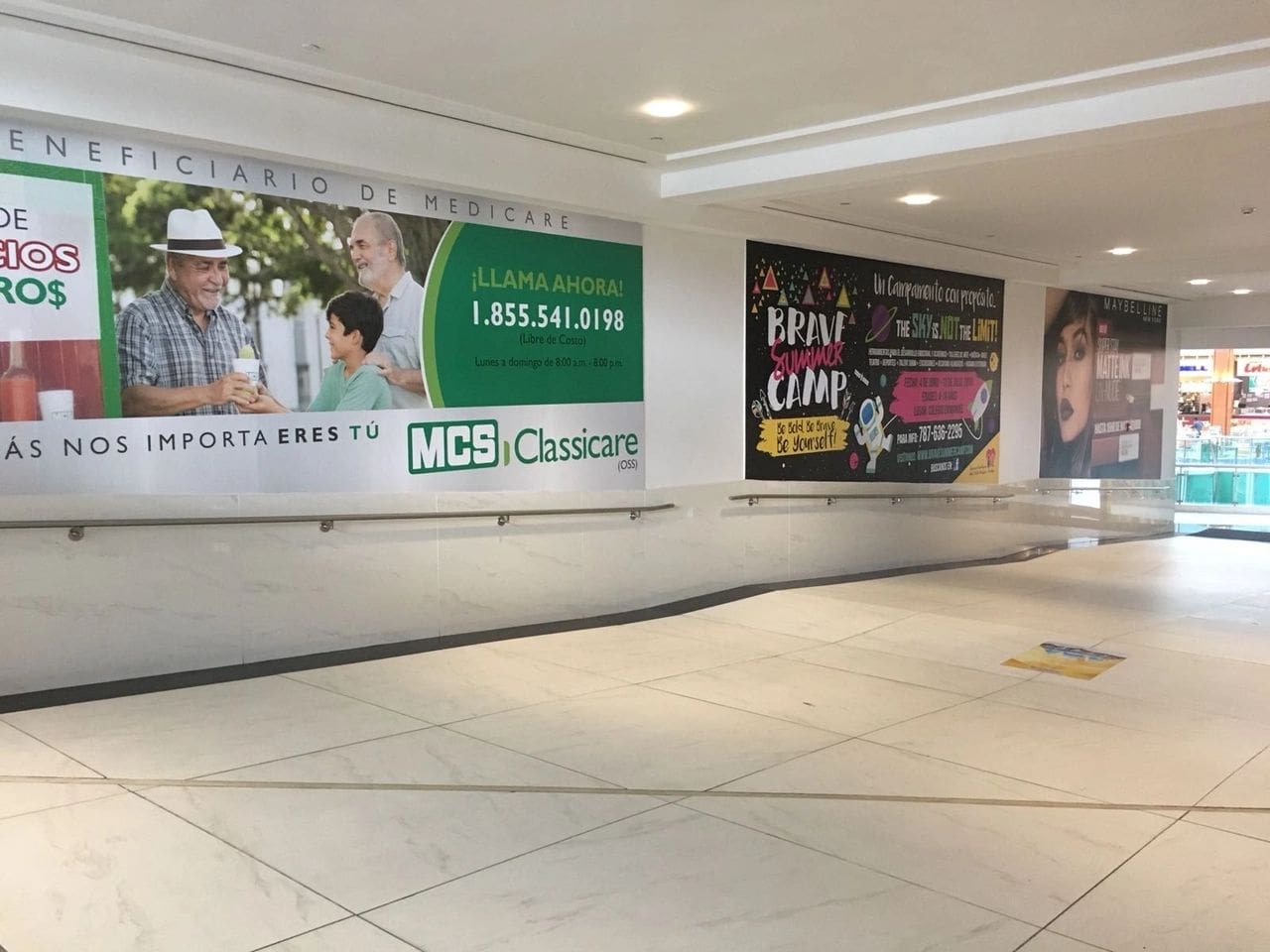 A mall with a lot of advertisements on the walls.